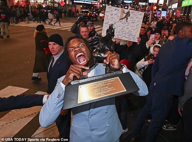 Travis Hunter pictured celebrating winning the 2024 Heisman Trophy in New York